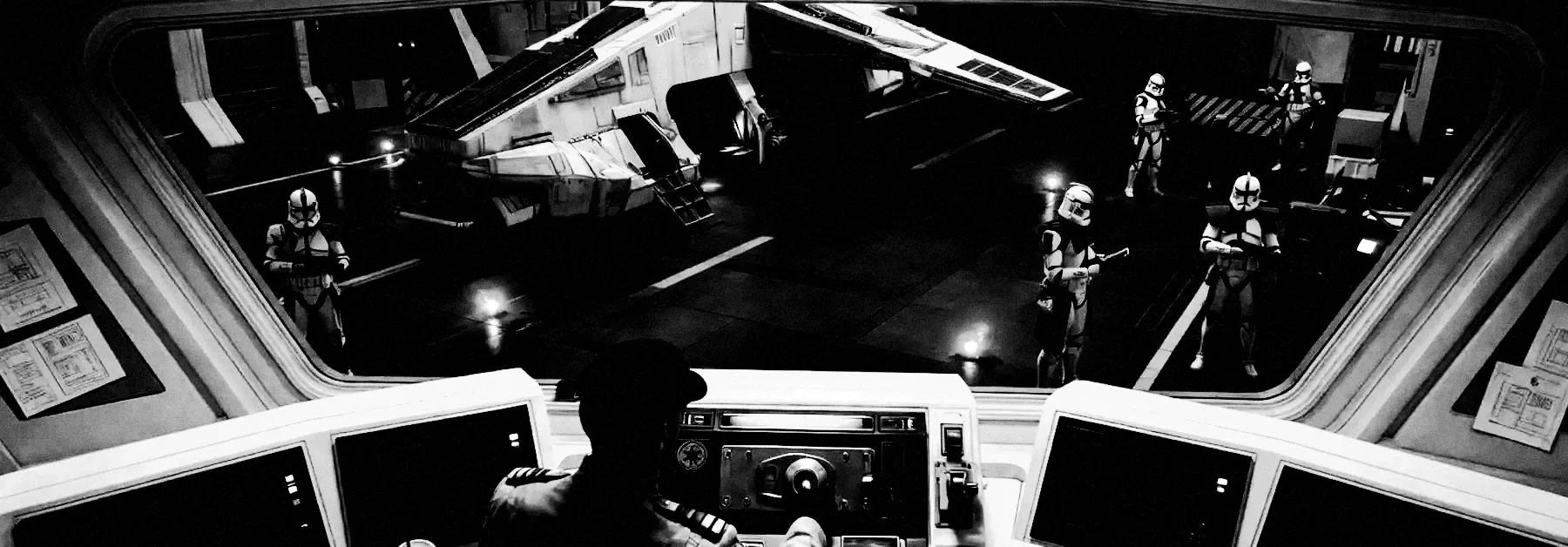 An officer watches an identical squad hold position around a docked shuttle.